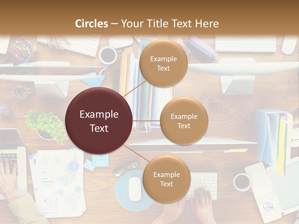 A Group Of People Sitting At A Table Working On Laptops PowerPoint Template