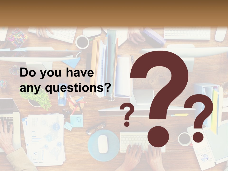 A Group Of People Sitting At A Table Working On Laptops PowerPoint Template