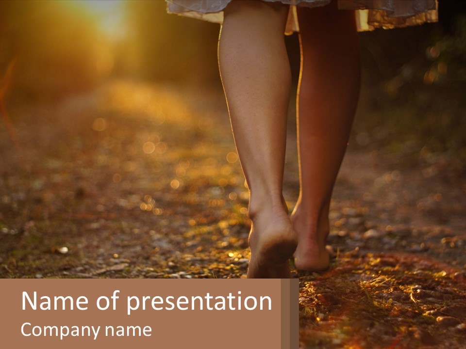 A Woman Walking Down A Dirt Road With Her Foot In The Air PowerPoint Template