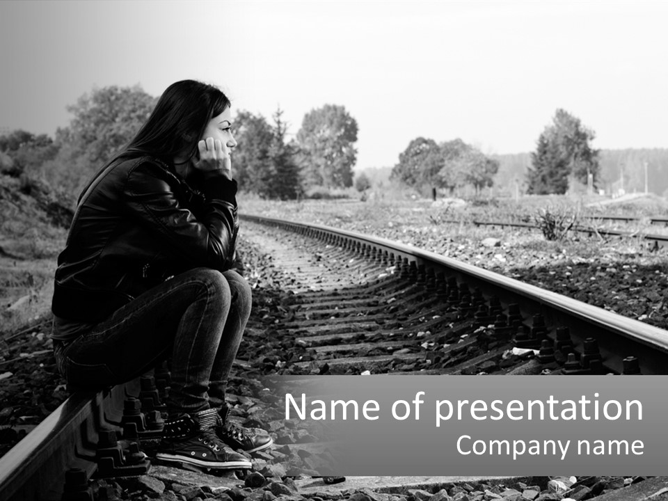 A Woman Sitting On A Train Track In Black And White PowerPoint Template