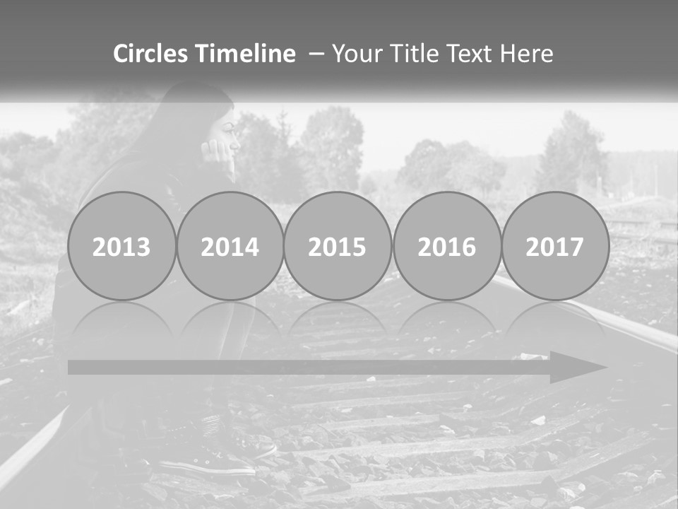 A Woman Sitting On A Train Track In Black And White PowerPoint Template