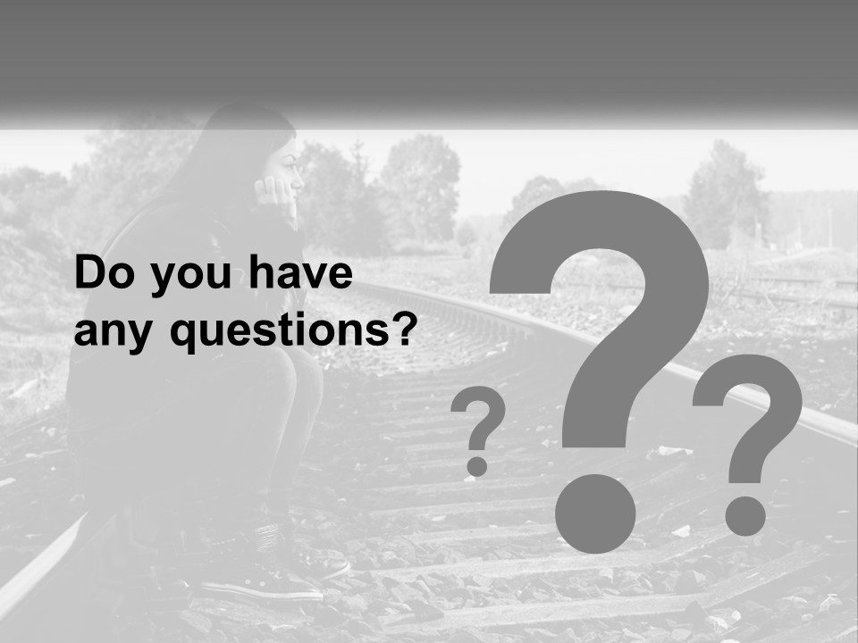 A Woman Sitting On A Train Track In Black And White PowerPoint Template