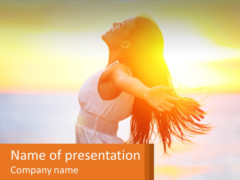 A Woman Standing On The Beach With Her Arms Outstretched PowerPoint Template