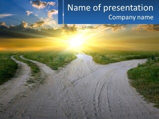 A Dirt Road With The Sun Setting In The Background PowerPoint Template