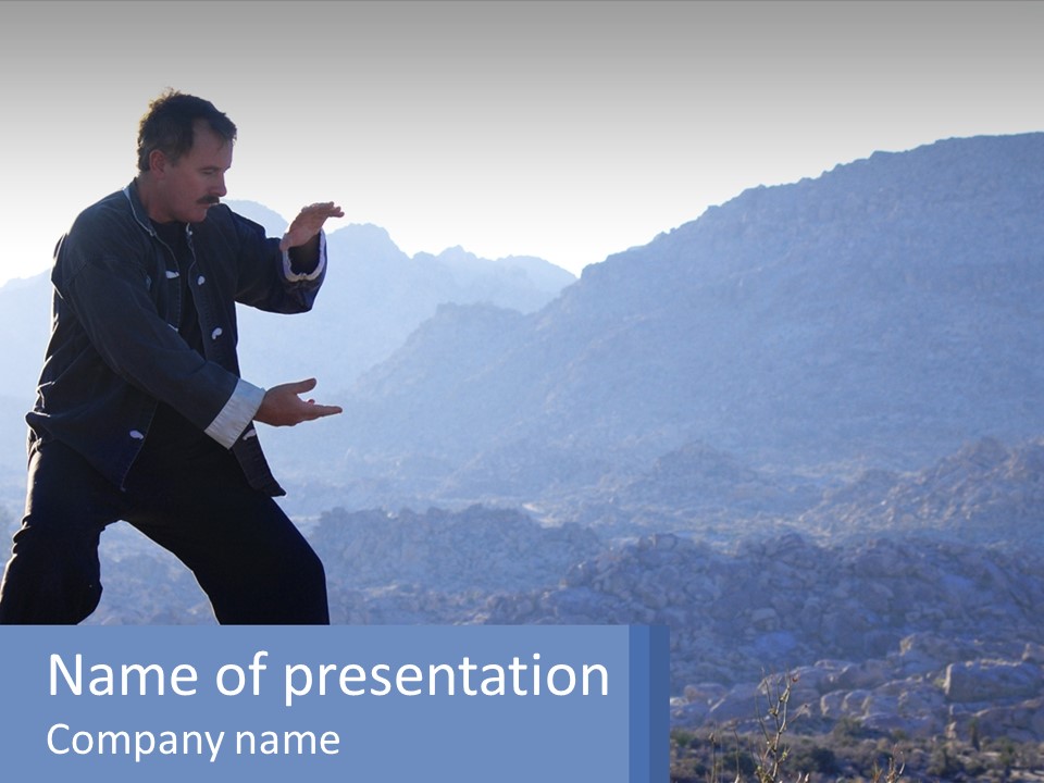 A Man Standing On Top Of A Mountain Pointing At Something PowerPoint Template