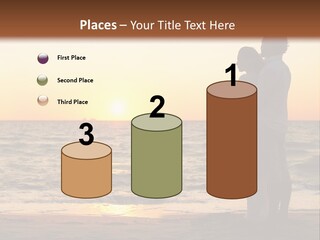 Two People Standing On A Beach At Sunset PowerPoint Template