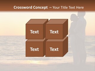 Two People Standing On A Beach At Sunset PowerPoint Template