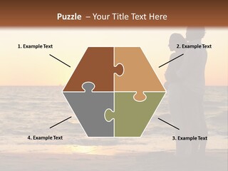 Two People Standing On A Beach At Sunset PowerPoint Template