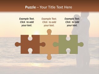 Two People Standing On A Beach At Sunset PowerPoint Template