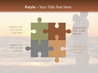 Two People Standing On A Beach At Sunset PowerPoint Template