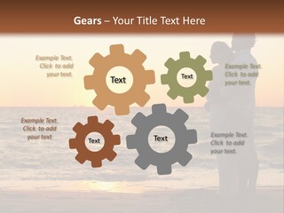 Two People Standing On A Beach At Sunset PowerPoint Template