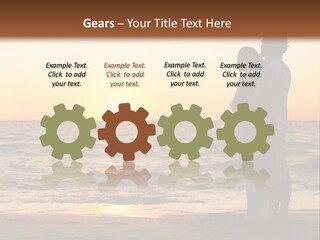Two People Standing On A Beach At Sunset PowerPoint Template