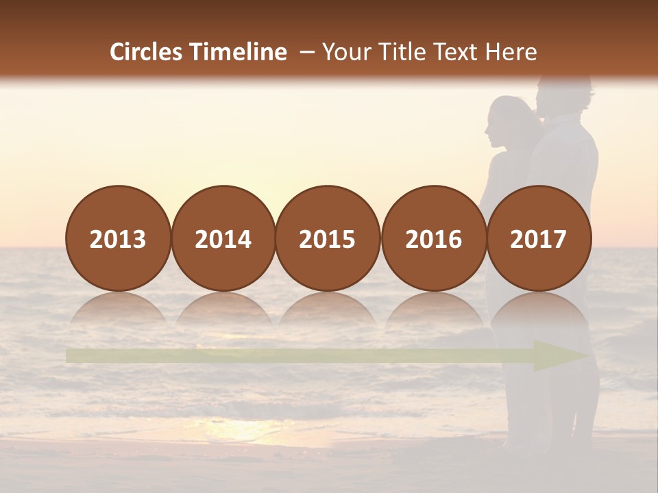 Two People Standing On A Beach At Sunset PowerPoint Template