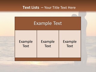 Two People Standing On A Beach At Sunset PowerPoint Template