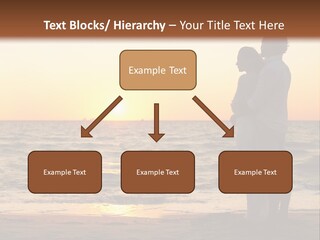 Two People Standing On A Beach At Sunset PowerPoint Template