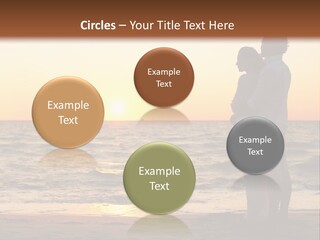 Two People Standing On A Beach At Sunset PowerPoint Template