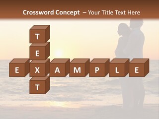 Two People Standing On A Beach At Sunset PowerPoint Template