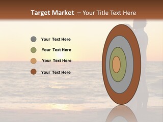 Two People Standing On A Beach At Sunset PowerPoint Template
