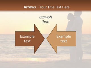 Two People Standing On A Beach At Sunset PowerPoint Template
