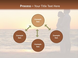 Two People Standing On A Beach At Sunset PowerPoint Template