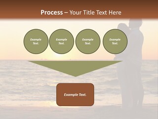 Two People Standing On A Beach At Sunset PowerPoint Template