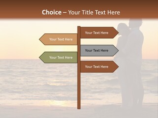 Two People Standing On A Beach At Sunset PowerPoint Template