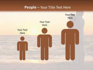 Two People Standing On A Beach At Sunset PowerPoint Template