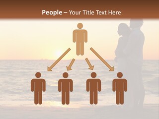 Two People Standing On A Beach At Sunset PowerPoint Template