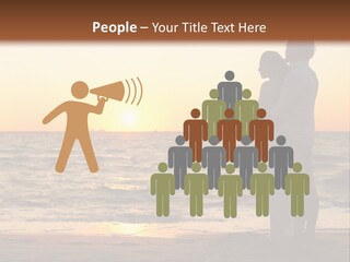 Two People Standing On A Beach At Sunset PowerPoint Template