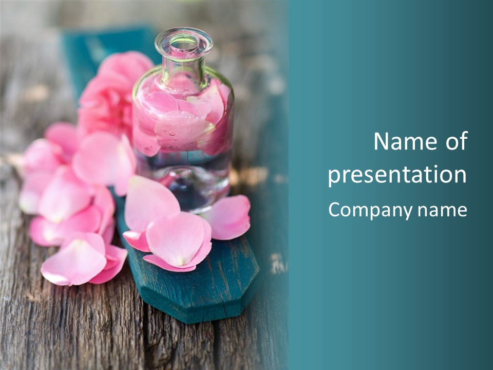 A Bottle Filled With Pink Flowers On Top Of A Wooden Table PowerPoint Template