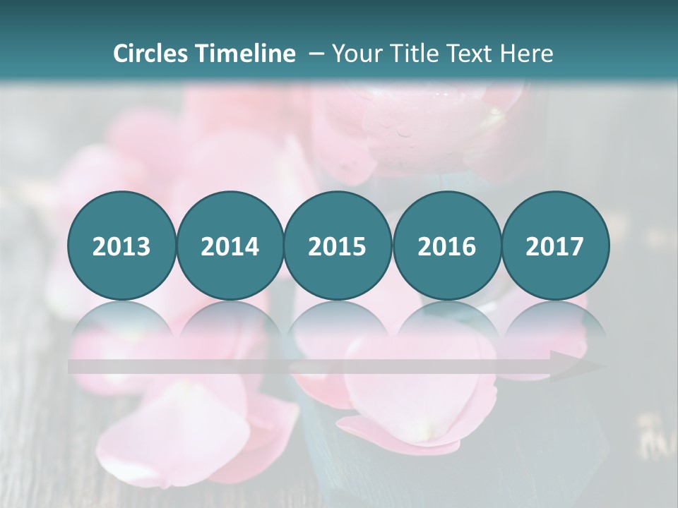 A Bottle Filled With Pink Flowers On Top Of A Wooden Table PowerPoint Template