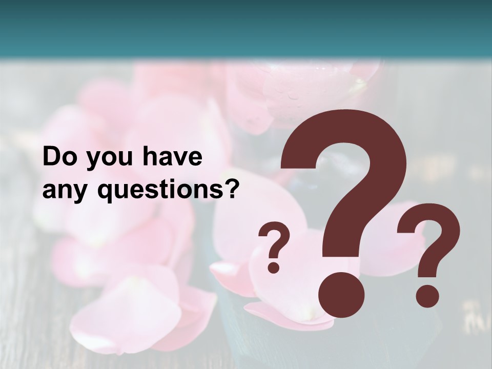 A Bottle Filled With Pink Flowers On Top Of A Wooden Table PowerPoint Template