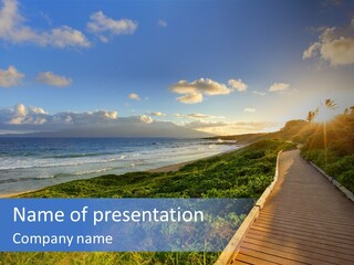 A Boardwalk Leading To The Beach With The Ocean In The Background PowerPoint Template