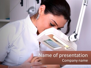 A Woman In A White Lab Coat Is Looking Through A Microscope PowerPoint Template
