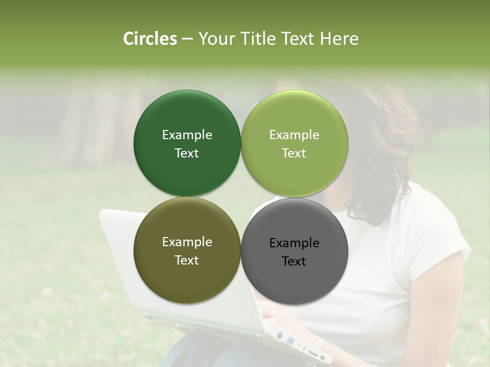 A Woman Sitting In The Grass Using A Laptop Computer PowerPoint Template
