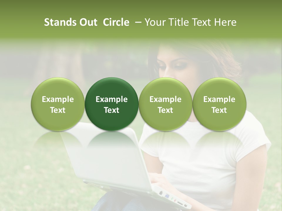 A Woman Sitting In The Grass Using A Laptop Computer PowerPoint Template