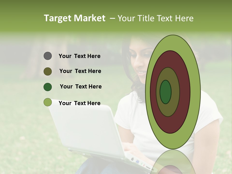 A Woman Sitting In The Grass Using A Laptop Computer PowerPoint Template