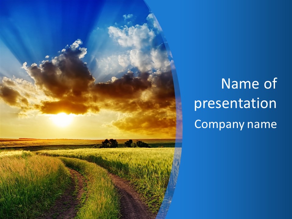 A Sunset Over A Field With A Dirt Road In The Foreground PowerPoint Template