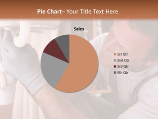 A Man Working On A Pipe In A Kitchen PowerPoint Template