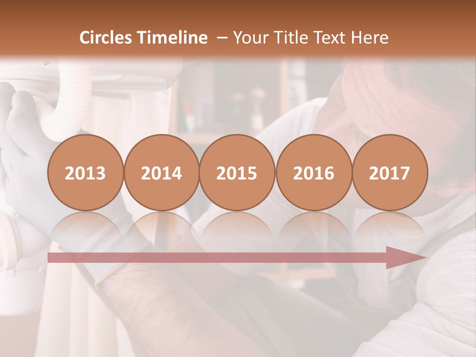 A Man Working On A Pipe In A Kitchen PowerPoint Template