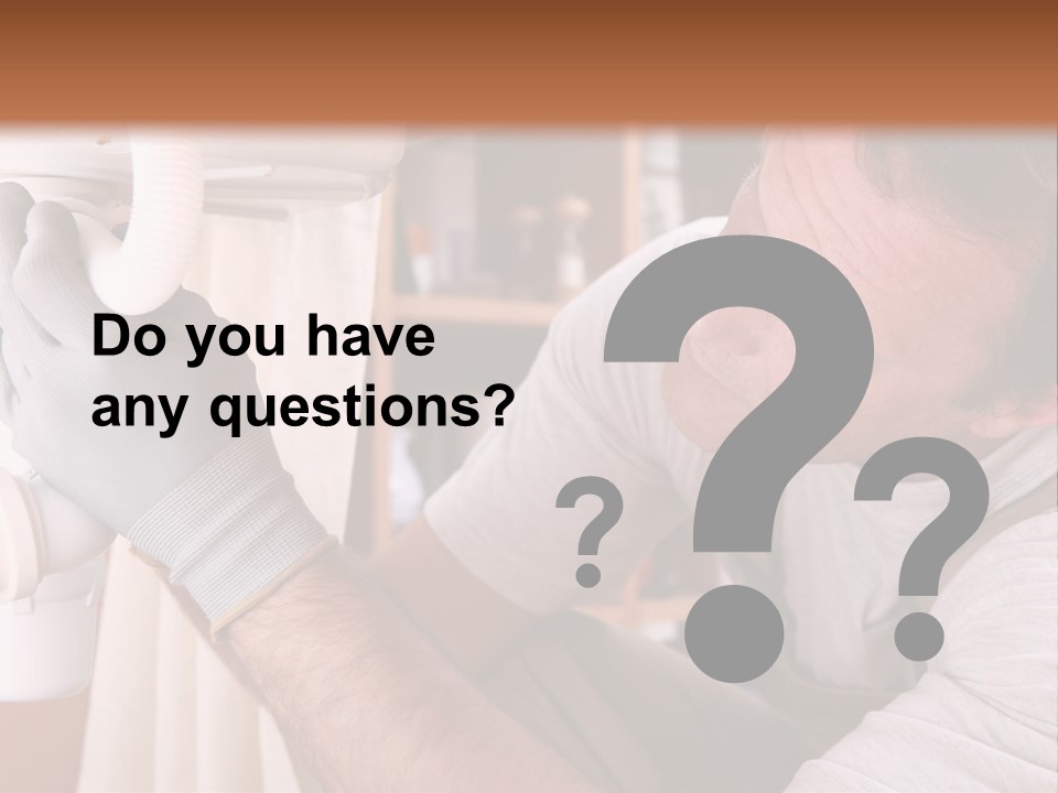 A Man Working On A Pipe In A Kitchen PowerPoint Template