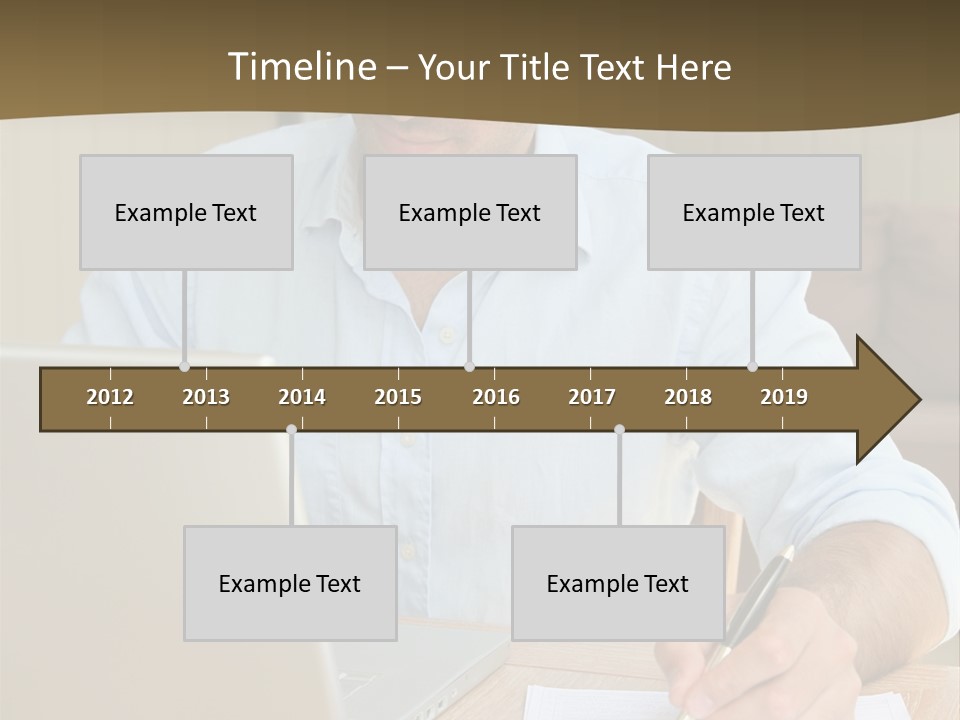 A Man Sitting At A Desk Writing On A Piece Of Paper PowerPoint Template