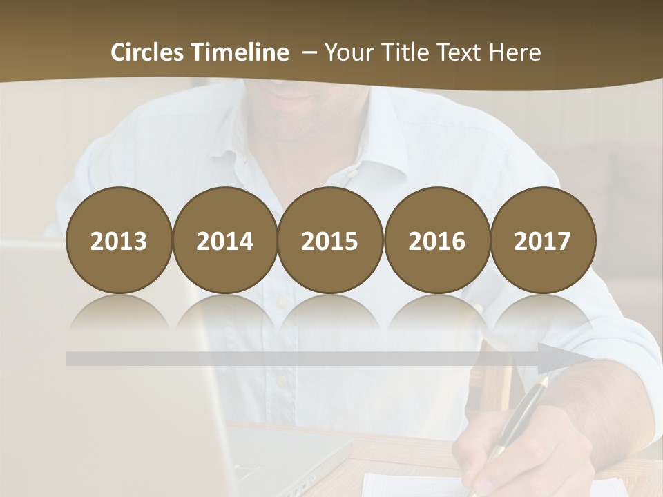 A Man Sitting At A Desk Writing On A Piece Of Paper PowerPoint Template