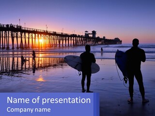A Couple Of People Holding Surfboards On A Beach PowerPoint Template