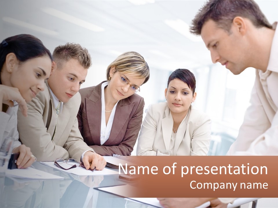 A Group Of Business People Looking At Something On A Table PowerPoint Template