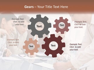 A Group Of Business People Looking At Something On A Table PowerPoint Template