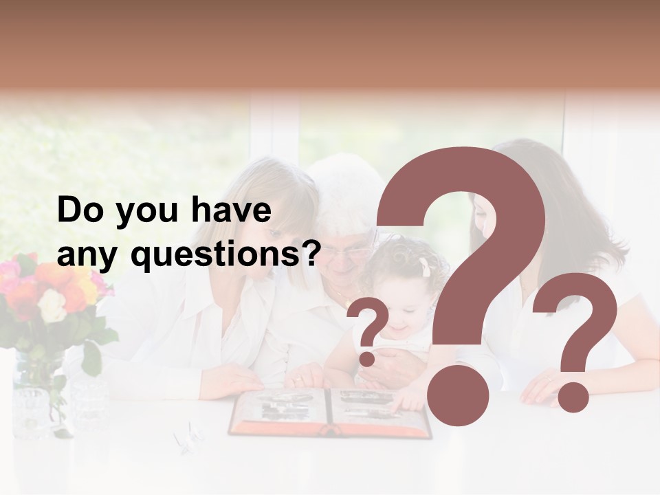 A Group Of People Sitting Around A Table With A Baby PowerPoint Template