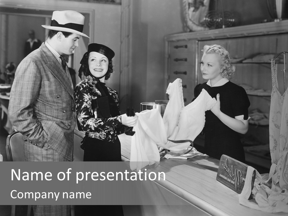 A Man And Two Women Standing In Front Of A Table PowerPoint Template