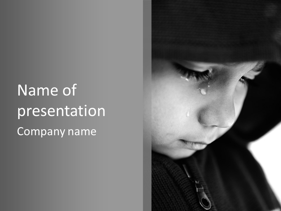A Young Boy Is Looking Down At His Cell Phone PowerPoint Template