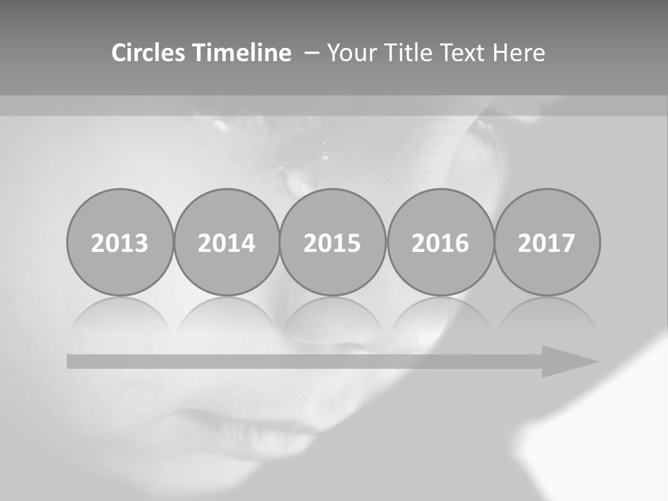 A Young Boy Is Looking Down At His Cell Phone PowerPoint Template